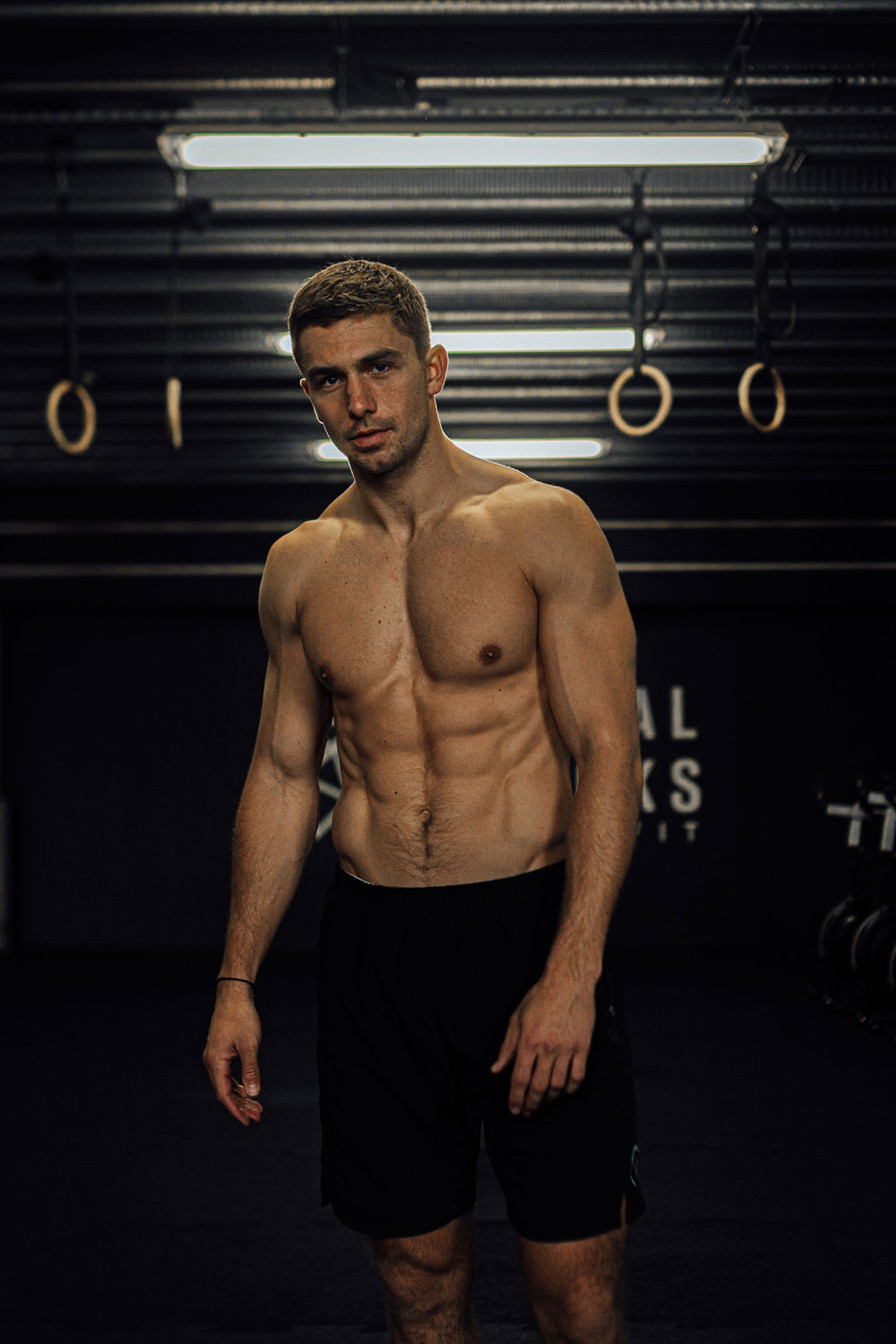 James Yates posing in dimly lit gym